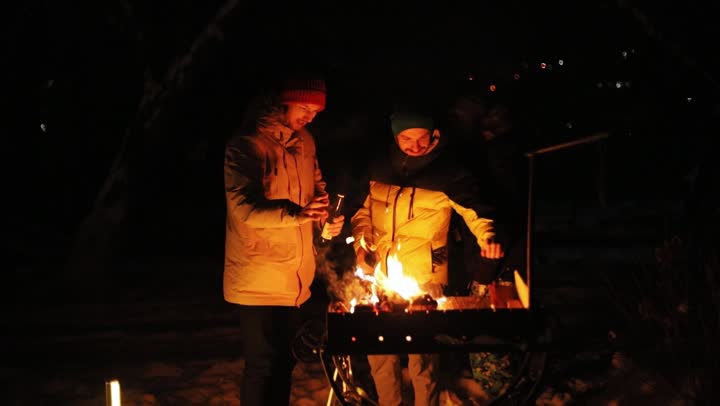 Friends around a bonfire at night