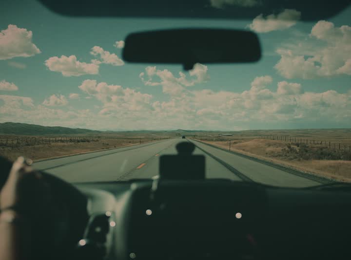 An open highway through a windshield